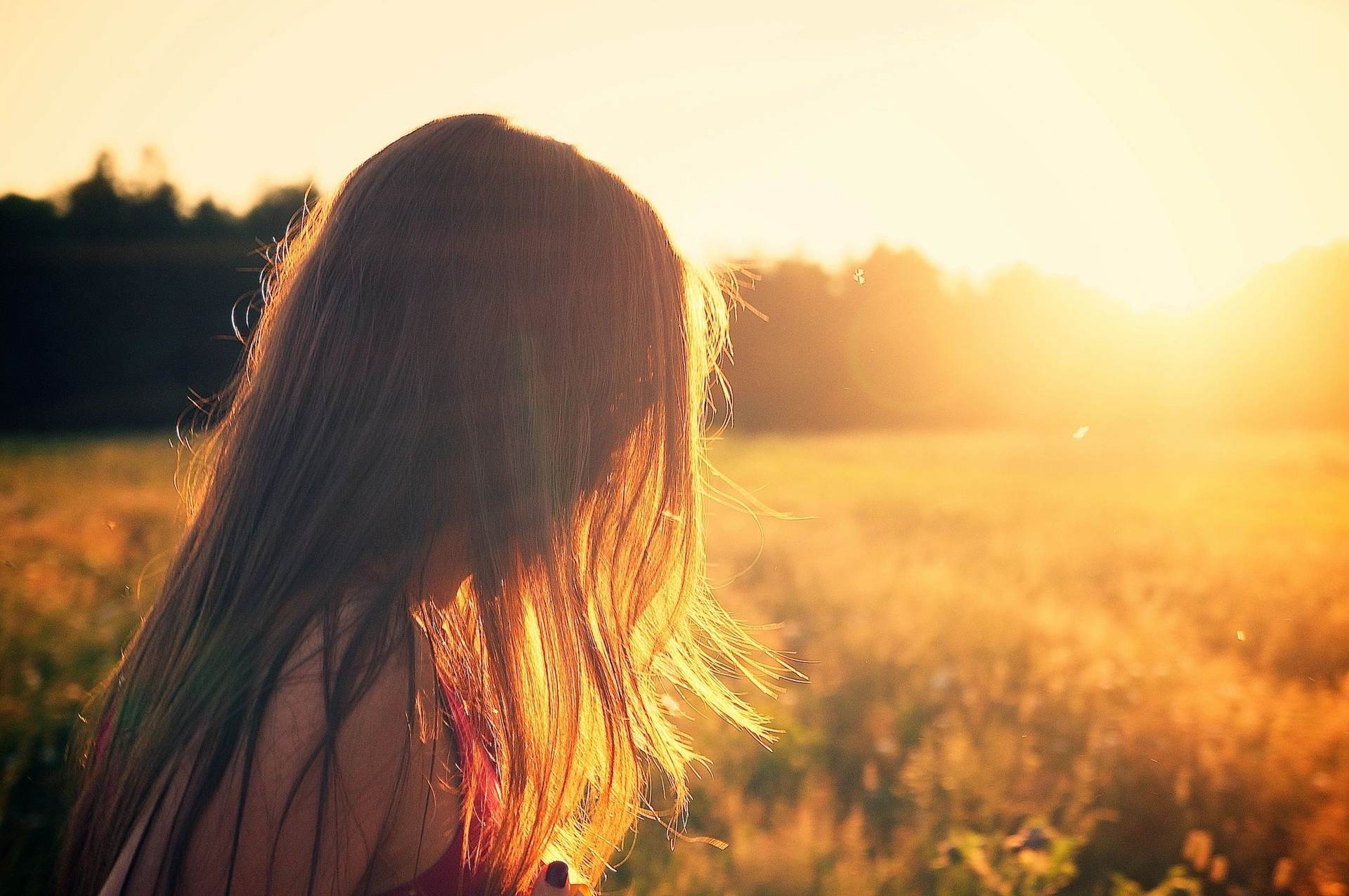 young girl staring into the sunset